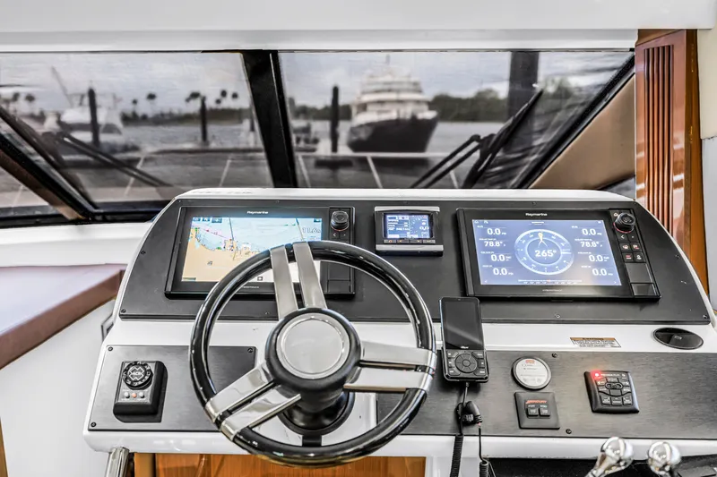 Slide: The Image of Helm of 2016 Sea Ray 510 Fly yacht with navigation displays and steering wheel. - 22