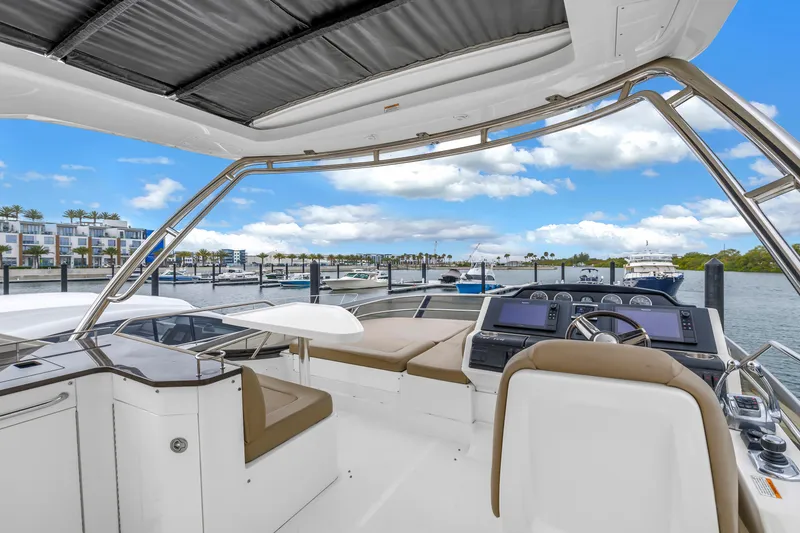 Slide: The Image of Flybridge view of 2016 Sea Ray 510 Fly yacht docked at marina. - 31