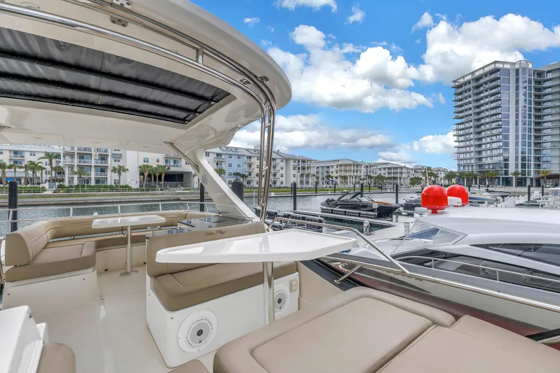 Slide: The Image of Luxurious 2016 Sea Ray 510 Fly yacht docked near modern waterfront buildings. - 39
