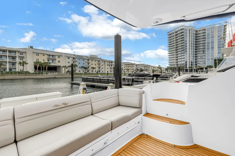 Slide: The Image of Luxurious 2016 Sea Ray 510 Fly yacht docked at a marina with modern buildings. - 45
