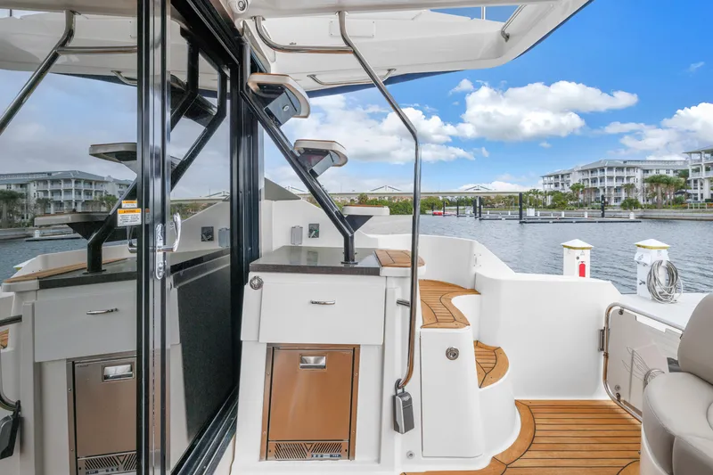 Slide: The Image of Luxurious 2016 Sea Ray 510 Fly yacht with elegant deck and marina view. - 47