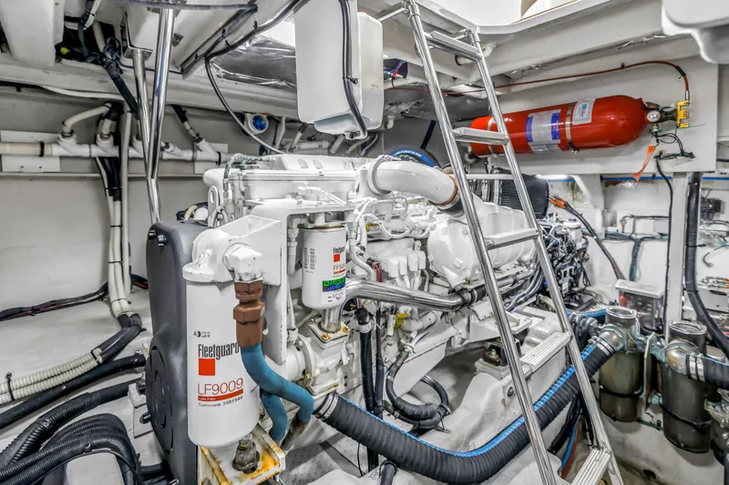 Slide: The Image of Engine room of 2016 Sea Ray 510 Fly yacht, featuring mechanical components and ladder. - 54