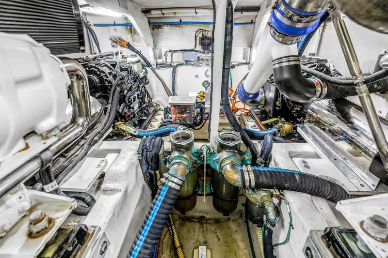 Slide: The Image of Engine room of a 2016 Sea Ray 510 Fly yacht, showcasing mechanical components. - 56