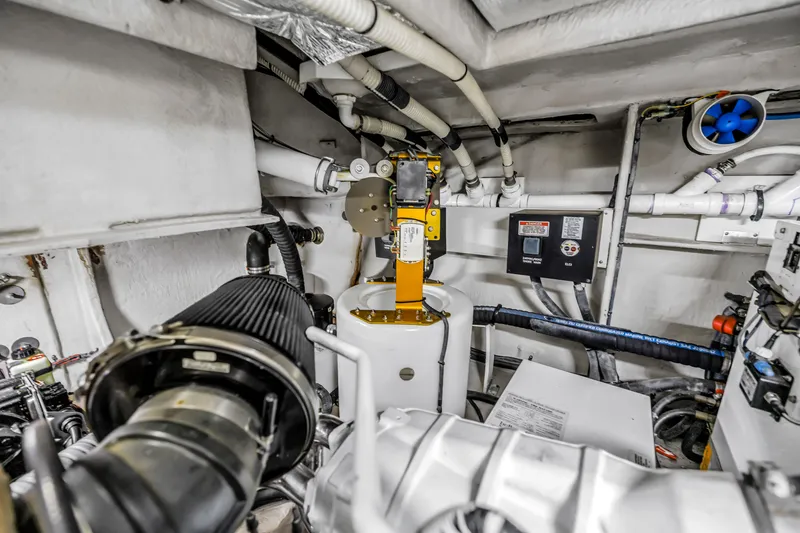 Slide: The Image of Engine room of a 2016 Sea Ray 510 Fly yacht, showcasing mechanical components and piping. - 57