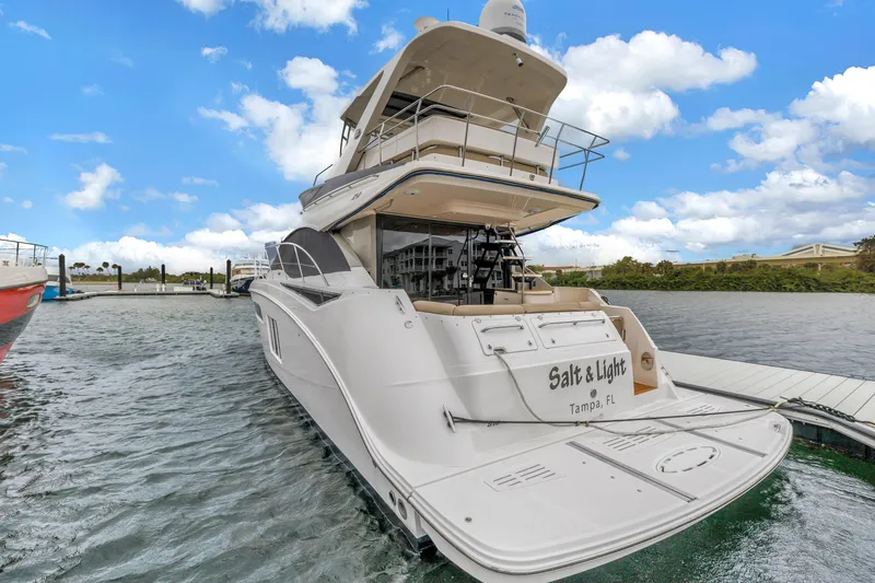 Slide: The Image of 2016 Sea Ray 510 Fly yacht docked in Tampa, Florida, under a bright blue sky. - 9