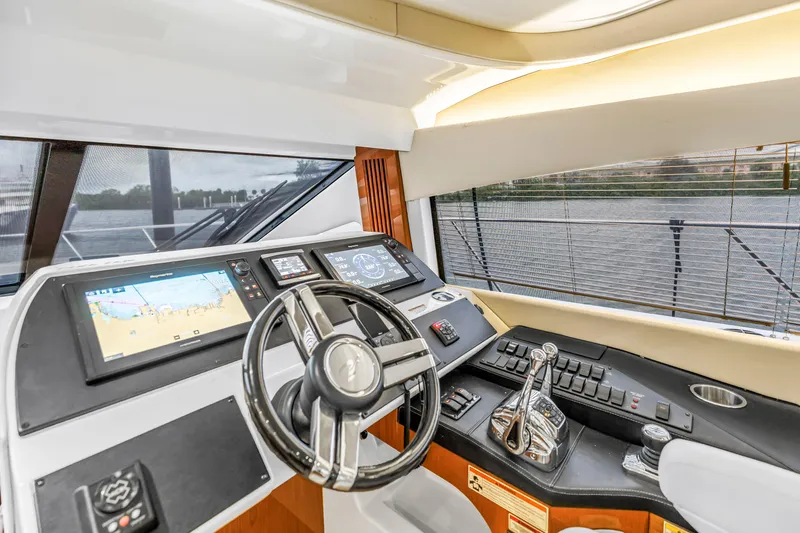Slide: The Image of Helm of 2016 Sea Ray 510 Fly yacht with modern navigation controls. - 23