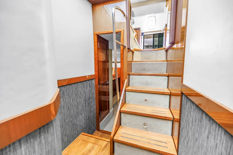 Slide: The Image of Interior staircase of 2016 Sea Ray 510 Fly yacht, featuring wooden steps and modern design. - 25