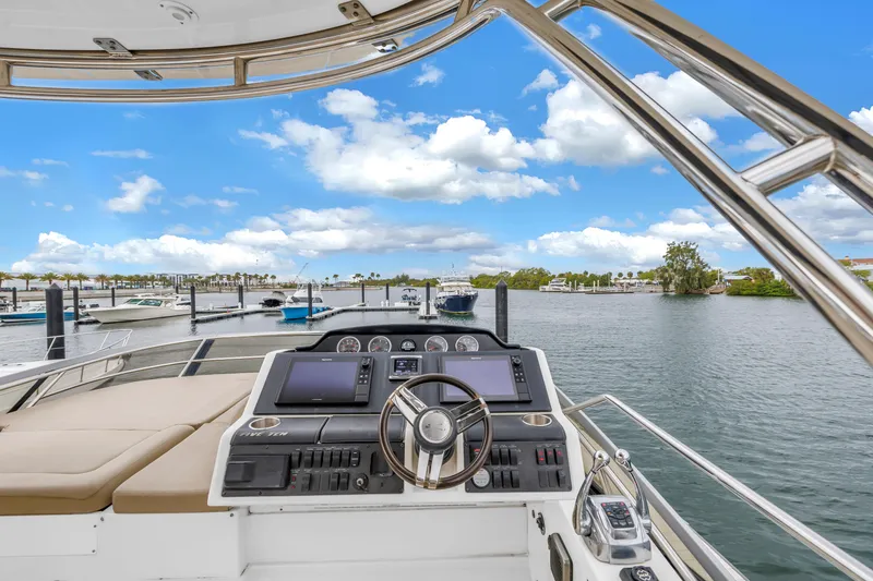 Slide: The Image of Flybridge view from 2016 Sea Ray 510 Fly yacht, overlooking marina and blue sky. - 32