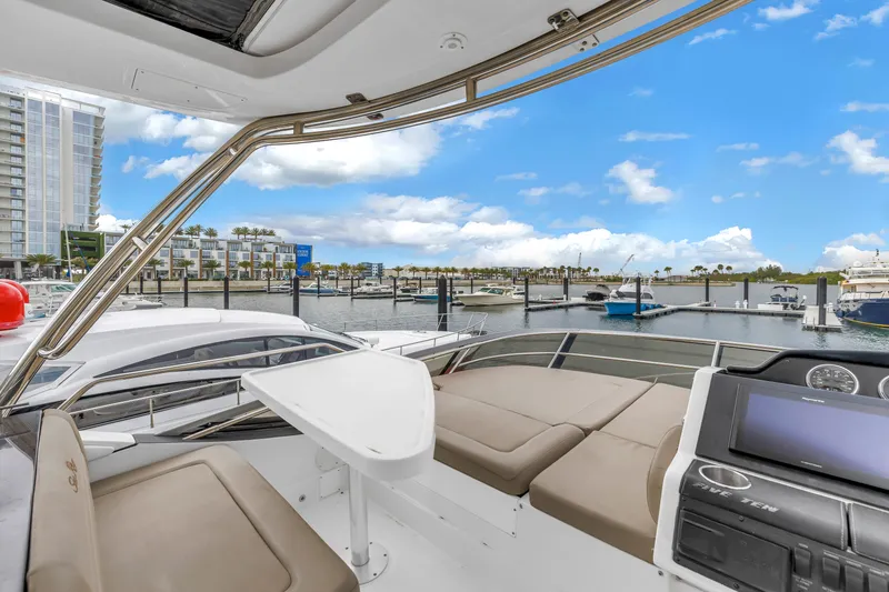 Slide: The Image of Luxurious 2016 Sea Ray 510 Fly yacht interior with marina view under blue sky. - 33
