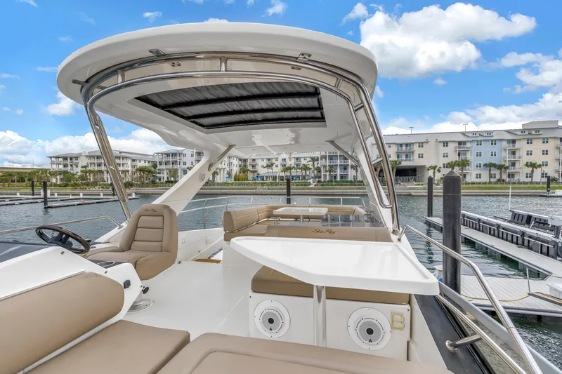 Slide: The Image of 2016 Sea Ray 510 Fly yacht at marina, featuring spacious deck and luxurious seating. - 38