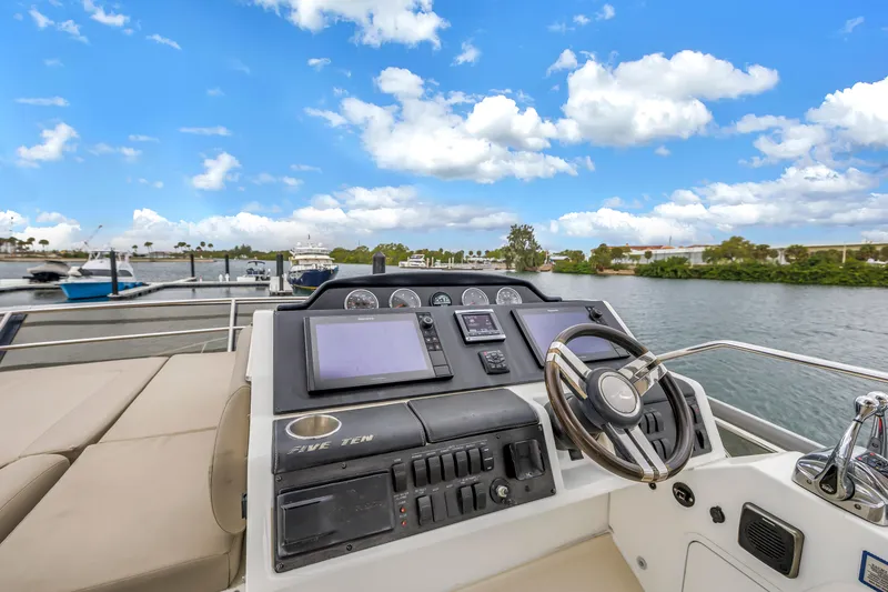 Slide: The Image of Flybridge helm of 2016 Sea Ray 510 Fly yacht with scenic marina view. - 41