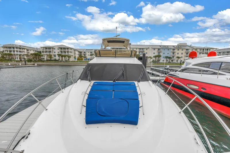 Slide: The Image of 2016 Sea Ray 510 Fly yacht docked at marina with blue cushions. - 48