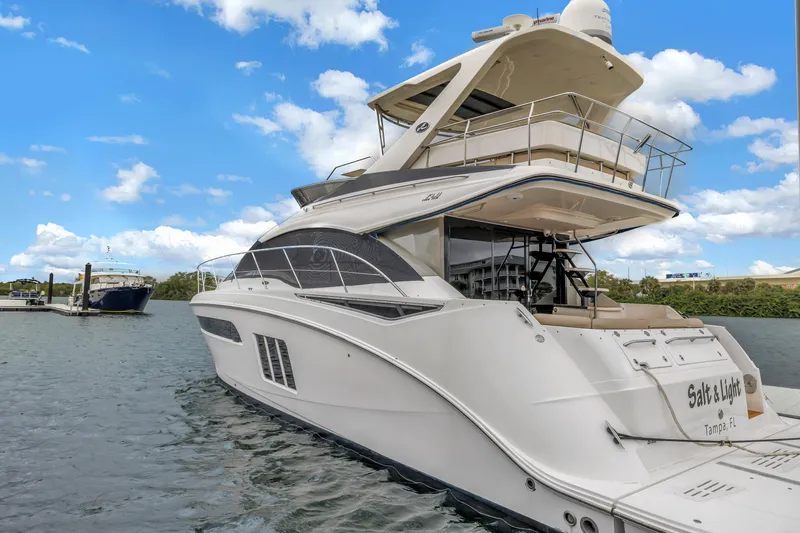Slide: The Image of 2016 Sea Ray 510 Fly yacht docked on a sunny day with blue skies. - 7