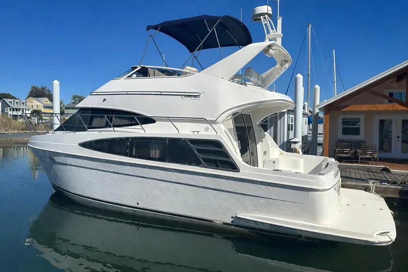 The Image of 2005 Carver 360 Sport Sedan yacht docked at marina under clear blue sky. - 0