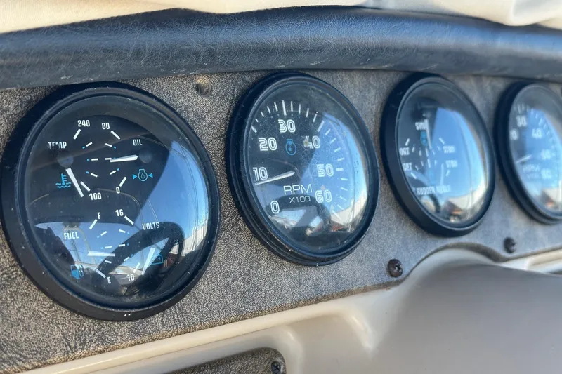 Slide: The Image of Dashboard gauges of a 2005 Carver 360 Sport Sedan, showing RPM and engine metrics. - 14