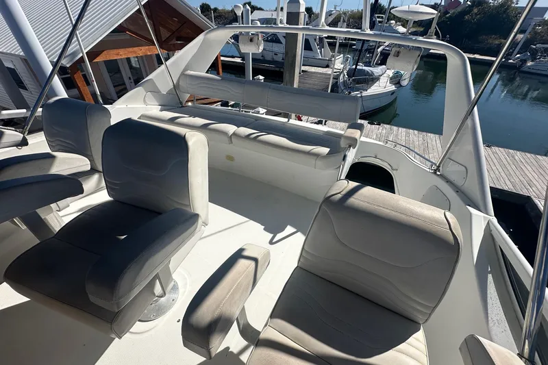Slide: The Image of 2005 Carver 360 Sport Sedan flybridge with seating, docked at marina. - 18