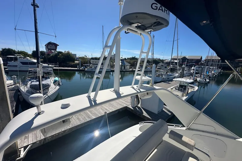 Slide: The Image of 2005 Carver 360 Sport Sedan docked at a marina with sailboats and clear skies. - 19