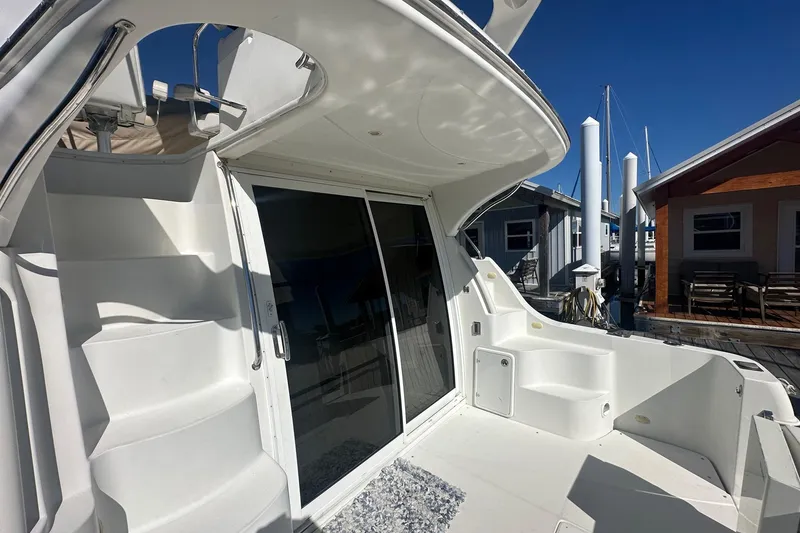 Slide: The Image of 2005 Carver 360 Sport Sedan yacht with sleek white exterior and marina backdrop. - 20