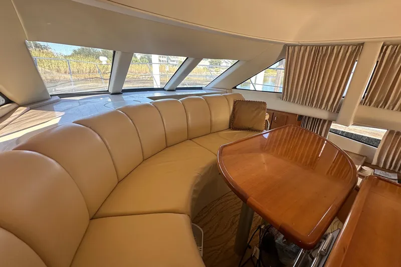 Slide: The Image of Luxurious interior of 2005 Carver 360 Sport Sedan with leather seating and wooden table. - 4