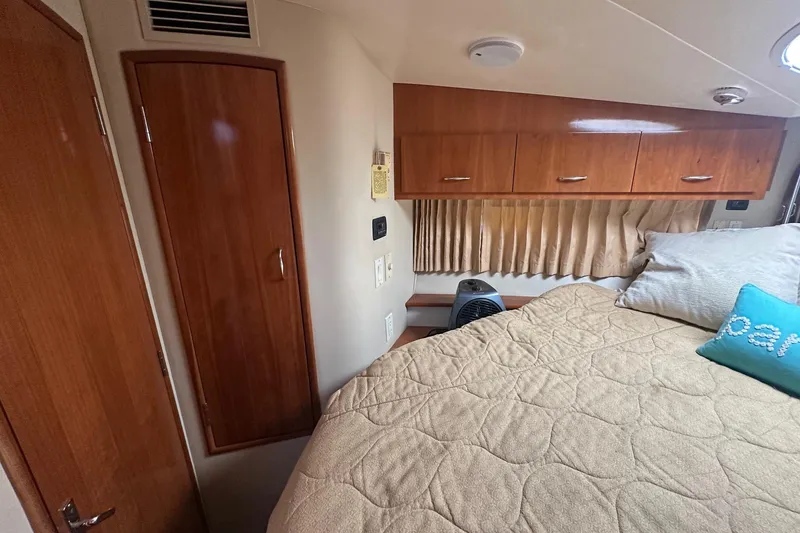 Slide: The Image of Interior of 2005 Carver 360 Sport Sedan with cozy bed and wooden cabinetry. - 5