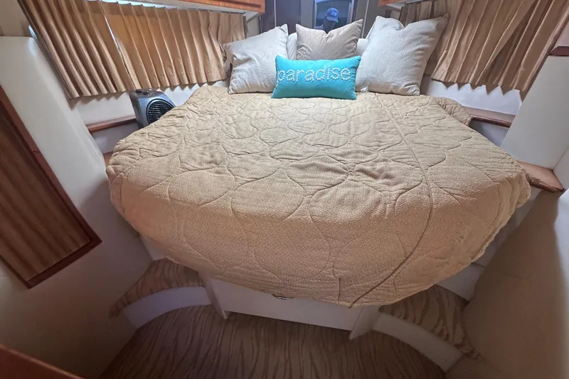 Slide: The Image of Cozy bedroom in 2005 Carver 360 Sport Sedan with beige bedding and "paradise" pillow. - 6