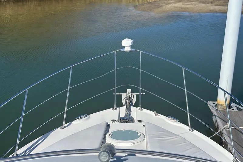 Slide: The Image of Bow view of 2005 Carver 360 Sport Sedan yacht docked by calm waters. - 9