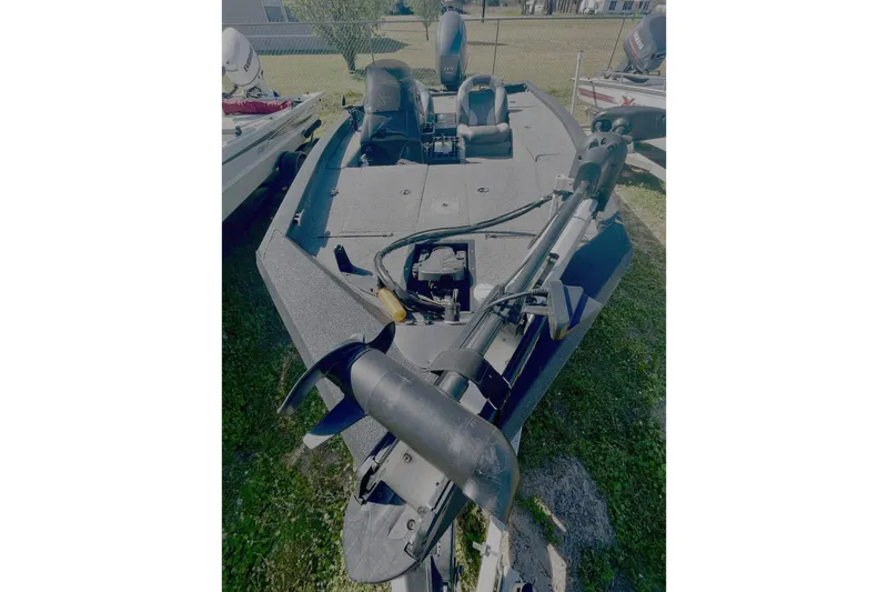 Slide: The Image of 2013 Xpress H18 boat with trolling motor on grassy area. - 2