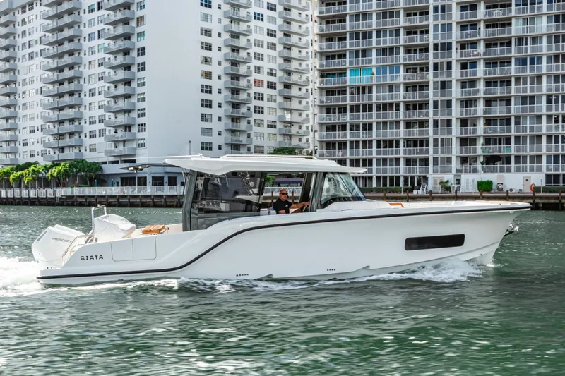 Slide: The Image of Aiata Wayfinder 38 Cabin 2026 on water near high-rise buildings. - 12