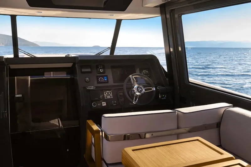 Slide: The Image of Interior view of 2026 Aiata Wayfinder 38 Cabin, featuring modern helm and ocean backdrop. - 14