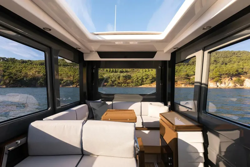 Slide: The Image of Interior of 2026 Aiata Wayfinder 38 Cabin yacht with panoramic windows and modern seating. - 15