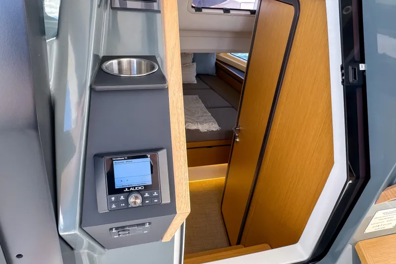 Slide: The Image of Interior of 2025 Aiata Wayfinder 38 Cabin with modern audio system and cozy sleeping area. - 27