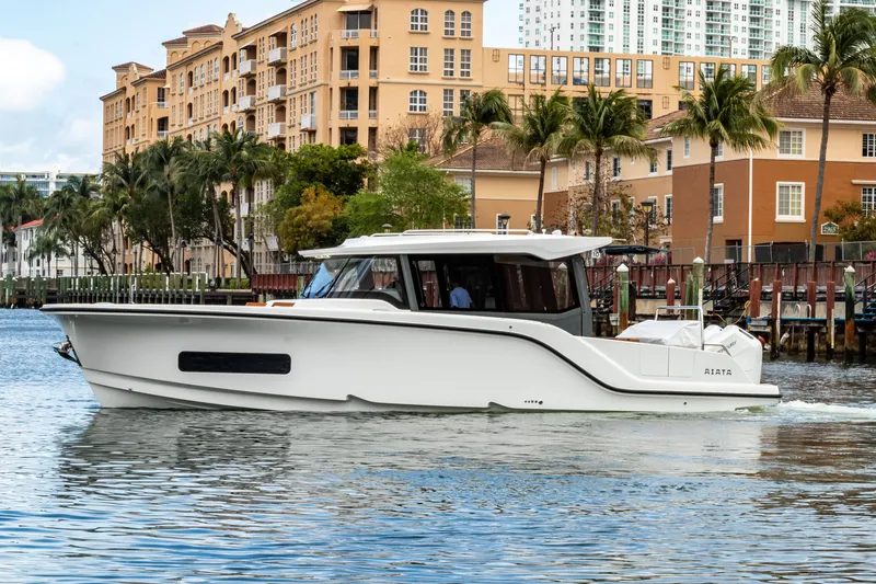 Slide: The Image of Aiata Wayfinder 38 Cabin 2026 on water with urban backdrop. - 4