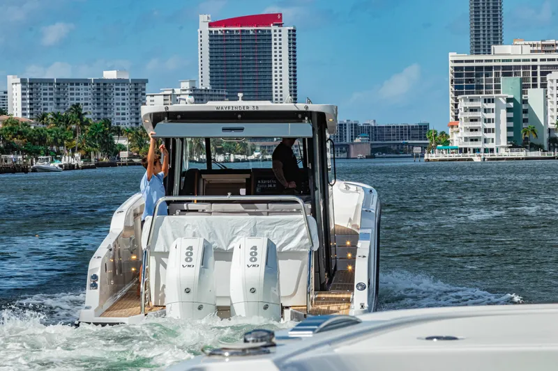 Slide: The Image of Aiata Wayfinder 38 Cabin 2026 on water with city buildings. - 7