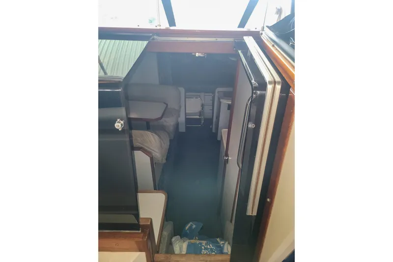 Slide: The Image of Interior view of 1987 Sea Ray 340 Express Cruiser cabin with seating and storage. - 10