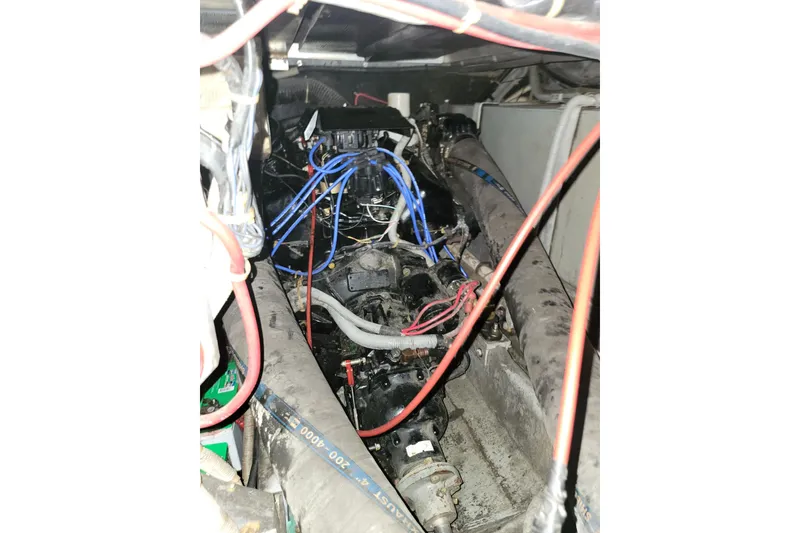 Slide: The Image of Engine compartment of a 1987 Sea Ray 340 Express Cruiser with visible wiring and components. - 20