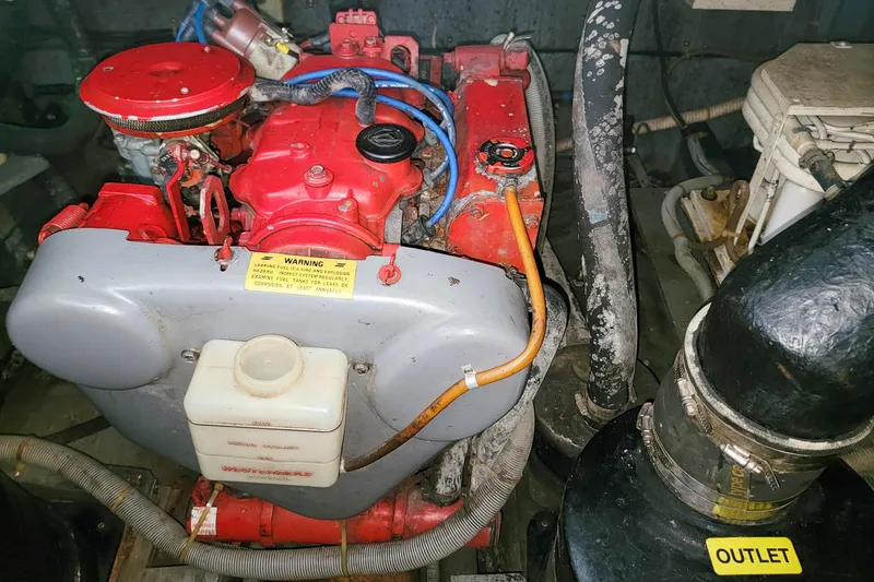Slide: The Image of Engine compartment of a 1987 Sea Ray 340 Express Cruiser with visible components and warning labels. - 21
