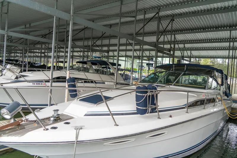Slide: The Image of 1987 Sea Ray 340 Express Cruiser docked in a covered marina. - 4