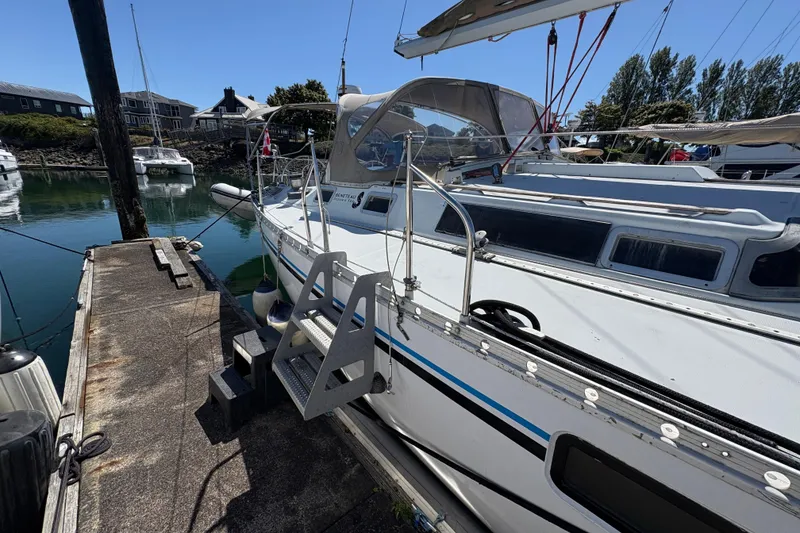Slide: The Image of Beneteau Oceanis 500 sailboat docked at marina, 1990 model, sunny day. - 10