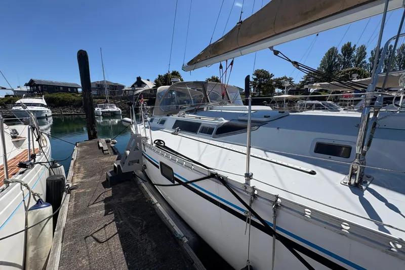 Slide: The Image of 1990 Beneteau Oceanis 500 sailboat docked at marina under clear blue sky. - 13