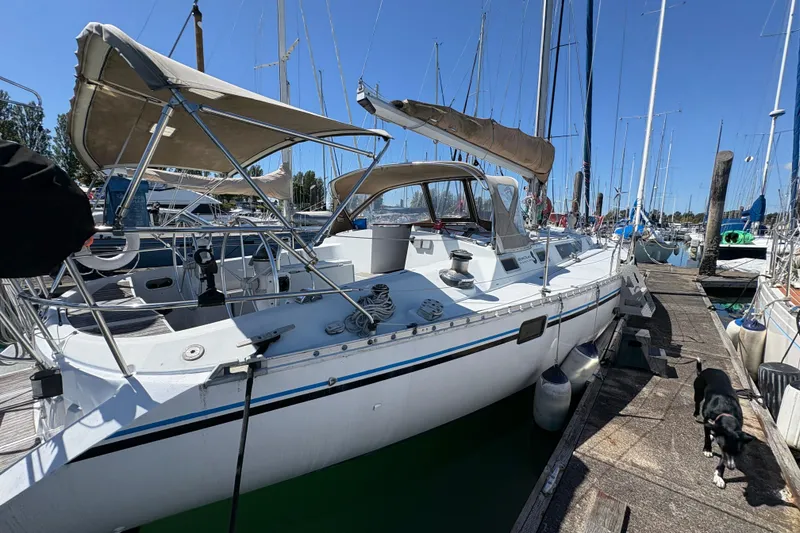 Slide: The Image of 1990 Beneteau Oceanis 500 sailboat docked at marina, sunny day, dog on pier. - 18