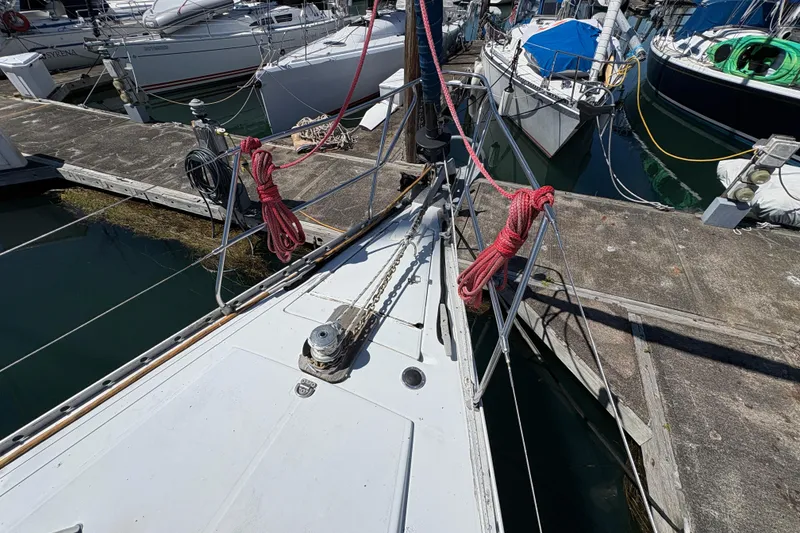 Slide: The Image of Bow of 1990 Beneteau Oceanis 500 yacht docked at marina with red ropes. - 21
