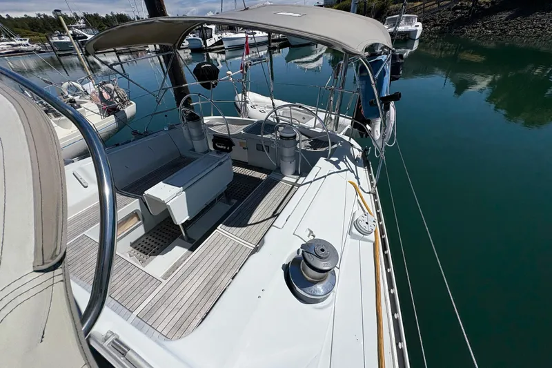 Slide: The Image of Beneteau Oceanis 500 sailboat, 1990 model, docked in a serene marina setting. - 32
