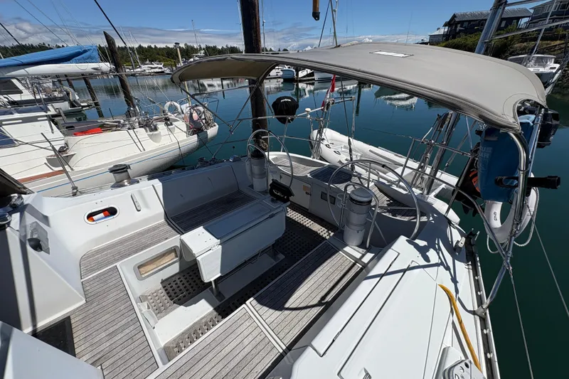 Slide: The Image of 1990 Beneteau Oceanis 500 sailboat cockpit with canopy, docked in a marina. - 33