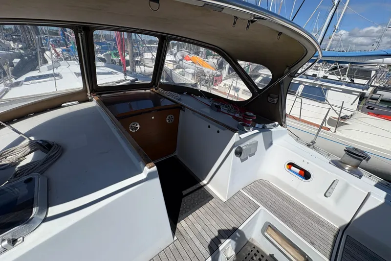 Slide: The Image of Cockpit of 1990 Beneteau Oceanis 500 sailboat, featuring spacious seating and navigation equipment. - 39