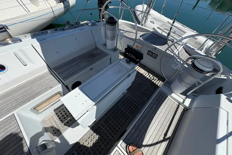 Slide: The Image of Cockpit of 1990 Beneteau Oceanis 500 sailboat, featuring a covered helm and marina view. - 41