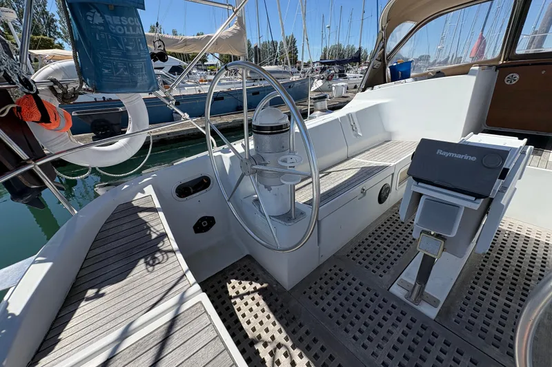Slide: The Image of Cockpit of 1990 Beneteau Oceanis 500 sailboat with steering wheel and navigation equipment. - 51