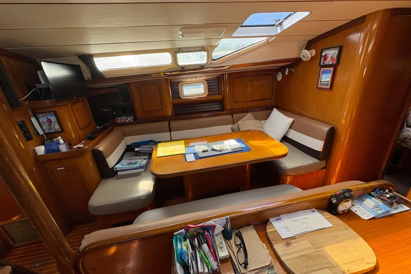 Slide: The Image of Interior of 1990 Beneteau Oceanis 500 sailboat with cozy seating and wooden finishes. - 59