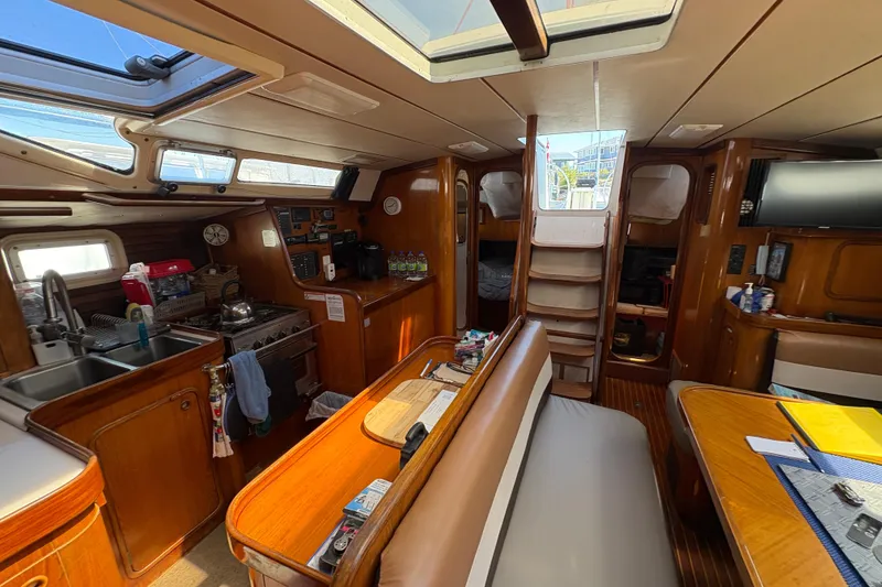 Slide: The Image of Interior of 1990 Beneteau Oceanis 500 sailboat with kitchen and seating area. - 63