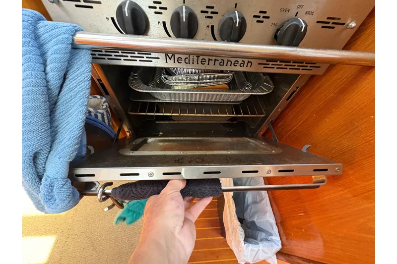 Slide: The Image of Oven in Beneteau Oceanis 500 yacht kitchen, showing open door and controls. - 69