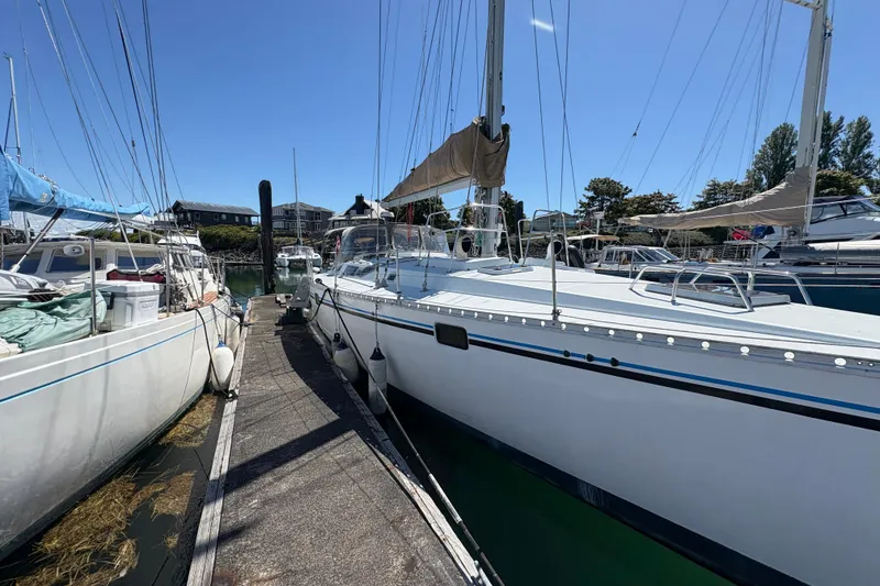 Slide: The Image of Sailboat Beneteau Oceanis 500, 1990 model, docked at marina under clear blue sky. - 7